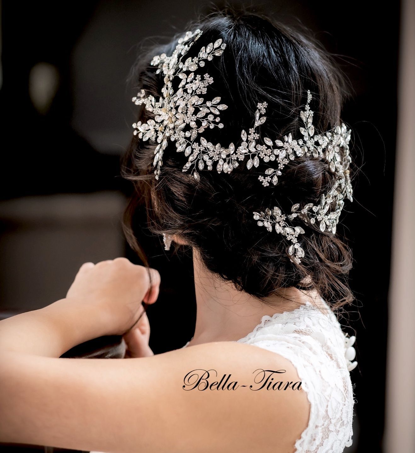A close-up image of a Swarovski crystal wedding hair vine worn on a Bridal headpiece, featuring intricate crystal patterns.
